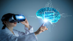 VR Experiences For Mental Health Training - Woman With Headset touching a virtual brain that is floating in front of her, a graphic square is highlighting the middle of the brain with circuitboard lines coming out of the square