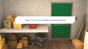 VR fire safety training scene, storage room with a table and lots of card board boxes and a text: "Shout "Fire Fire!"and break the manual call point"