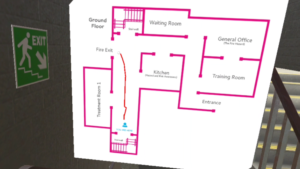 VR fire safety training scene, staircase with exit sign and floor plan showing fire exit route