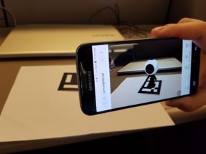 WebAR - robot appearing on phone screen when held over a geometric shape