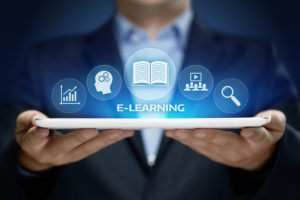 E-learning Illustration - Man Holding Tablet Device with icons of a chart, head with cogs, book, audience with play button and magnifying glass
