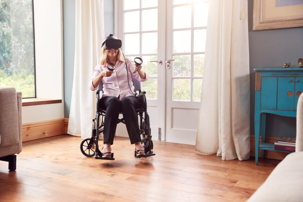 woman in wheelchair using virtual reality headset