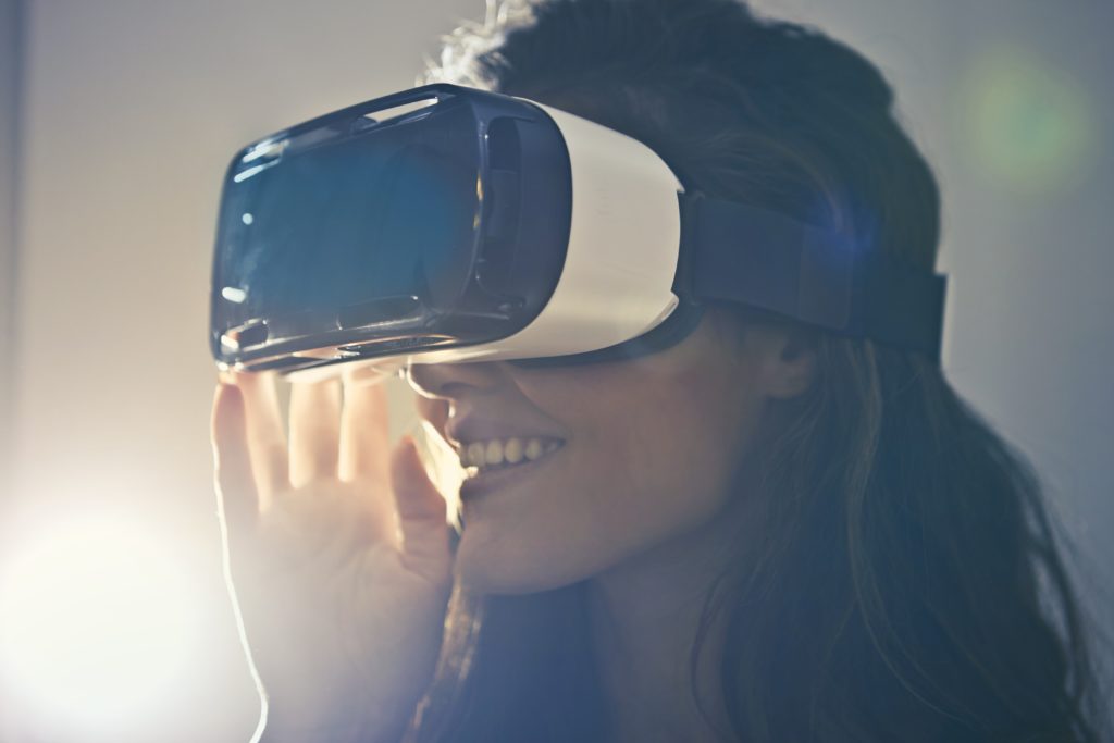 close up shot of woman with long hair wearing white virtual reality goggles