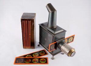 Picture of an antique magic lantern with example image slides