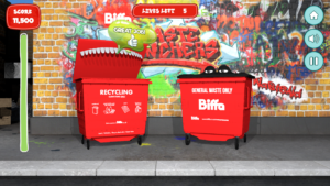 Biffa Waste munchers gameplay, the Recycling Bin and the General waste bin against a graffiti-d wall, with the Recyling bin's mouth open and the text bubble saying 'Great Job!' coming out