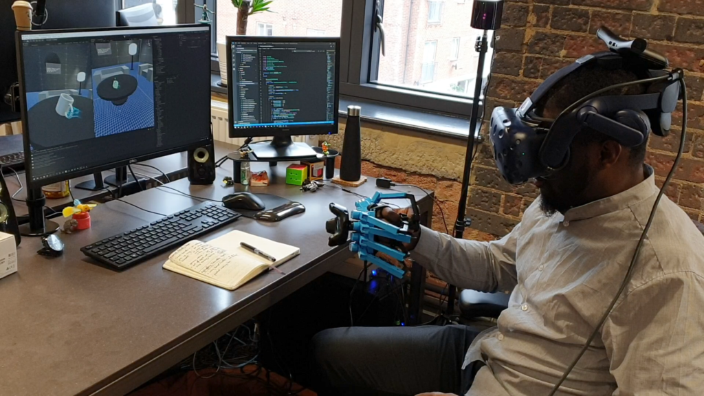 Man tests VR headset and Haptic Feedback Gloves