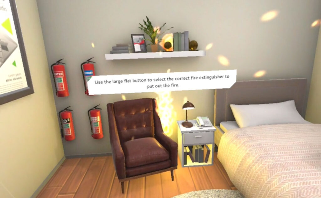 Still from VR Fire Safety training of a hospital room with the plug socket on fire, and the text 'Use the large flat button to select the correct fire extinguisher to put out the fire