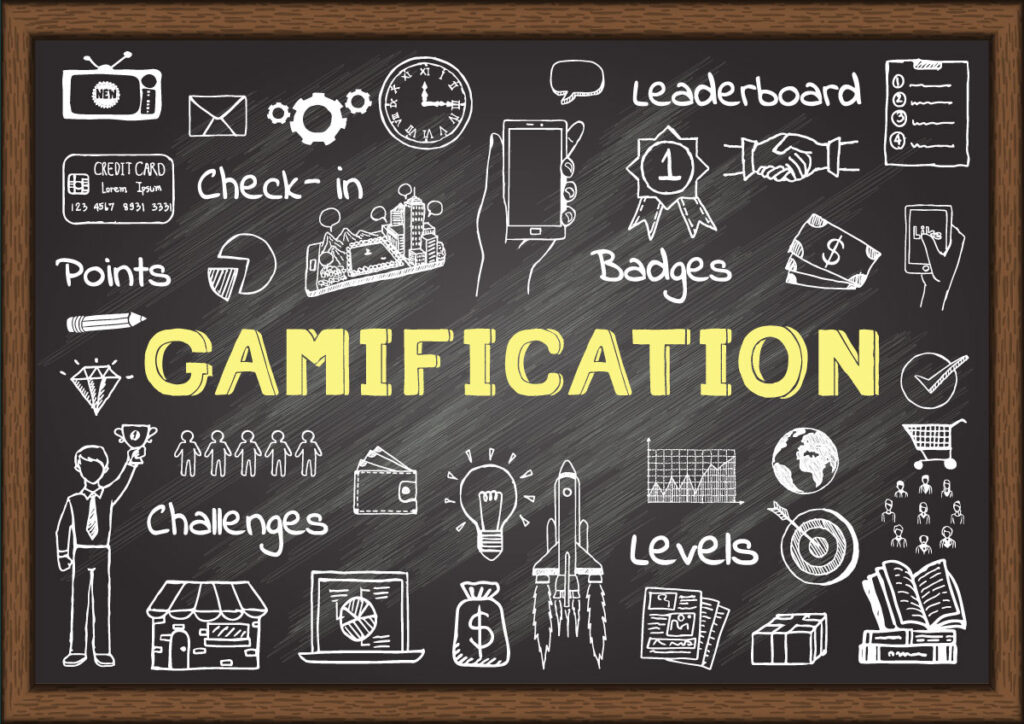 The word Gamification written on a chalk board, with icons relating to gamification drawn around it