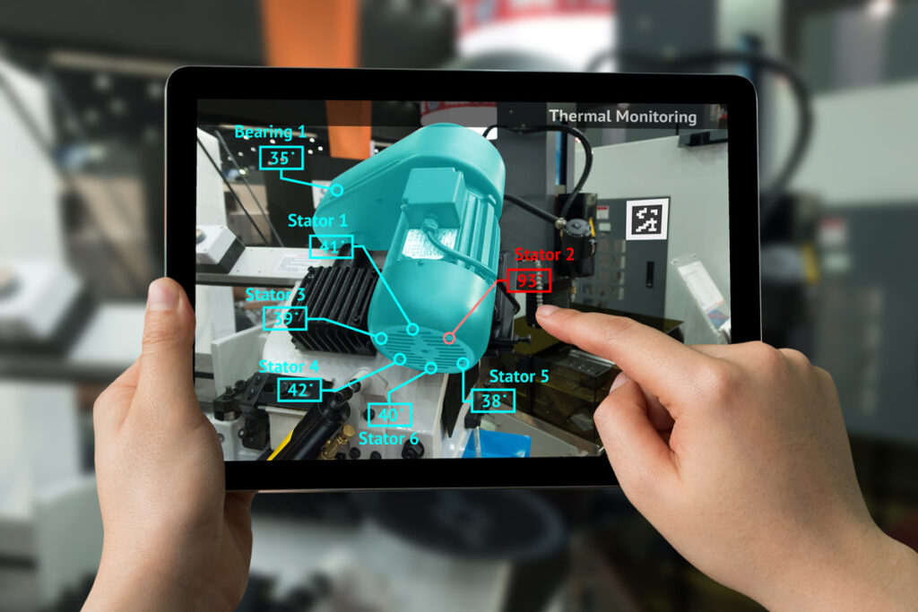 A person holding a tablet that shows an engine in AR identifying different parts of an engine