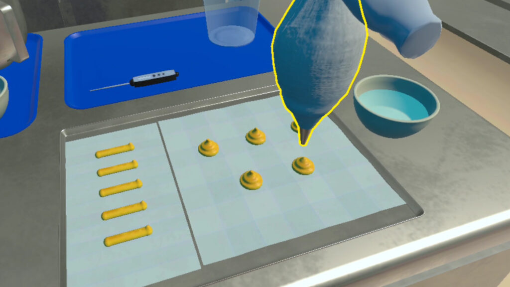 A screengrab from the VR Cooking Training showing the user piping profiteroles and eclairs
