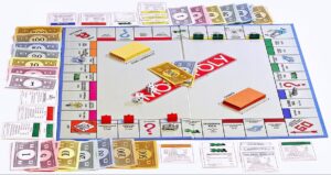 Monopoly Board with monopoly money and cards around the board