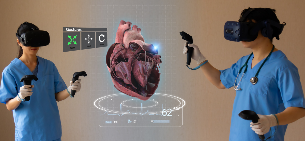 Two medical professionals with VR headsets on viewing a 3D model of a heart in the AR space