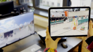 tablet displaying AR construction training, overlaying hazard awareness training visuals onto a real site environment to support safety training